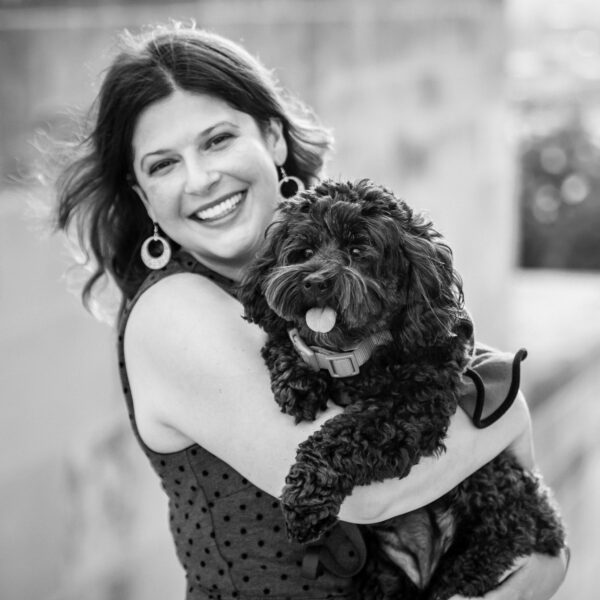 This is a photo by Tonya Dean Photography of Kat Stano happily hugging her dog Cosette.