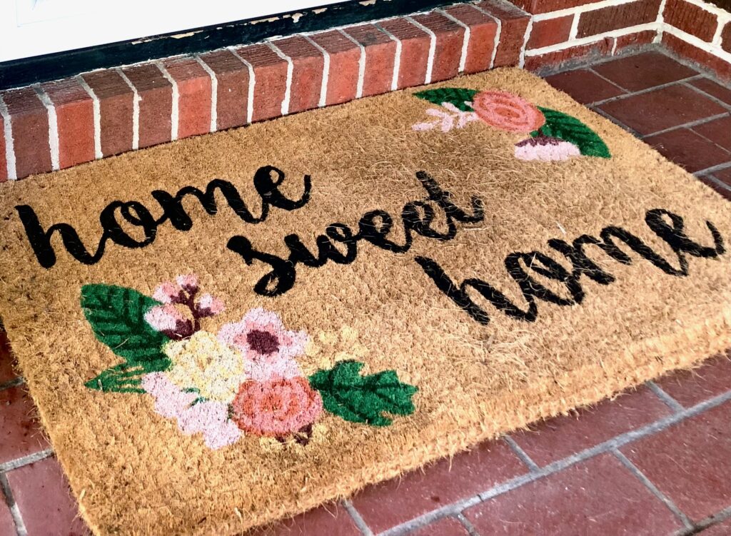 This is a photo of a doormat that says, "Home Sweet Home."