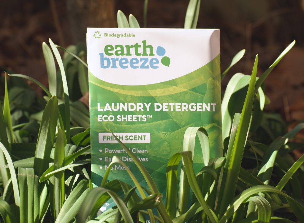 This is a photo by Kat Stano of an Earth Breeze package sitting in day lilies as her best laundry detergent strips.