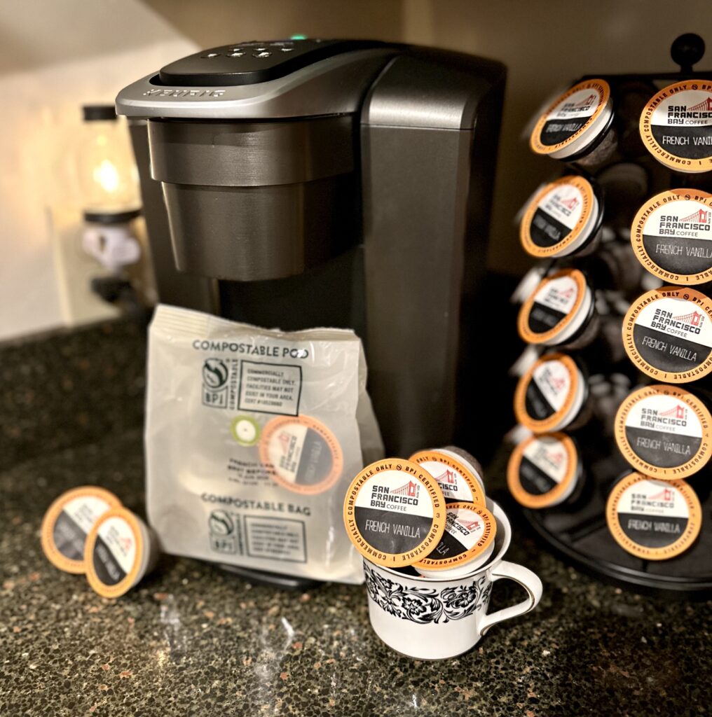 This is a photo of a Keurig with San Francisco Bay Coffee compostable coffee pods to demonstrate eco-friendly solutions associated with biodegradable coffee pods for Keurig.