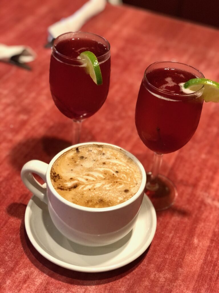 This is a photo of two sangrias and a chai in a coffee cup.