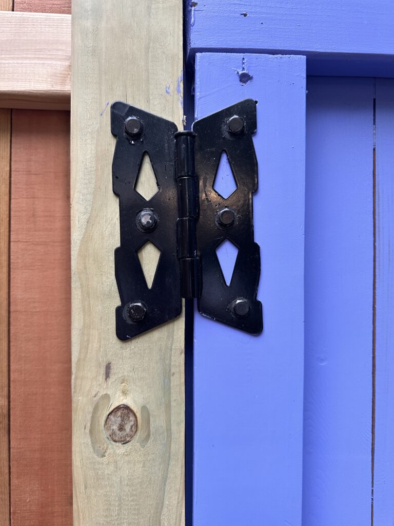 This is a photo of a butterfly hinge on the secret garden door.