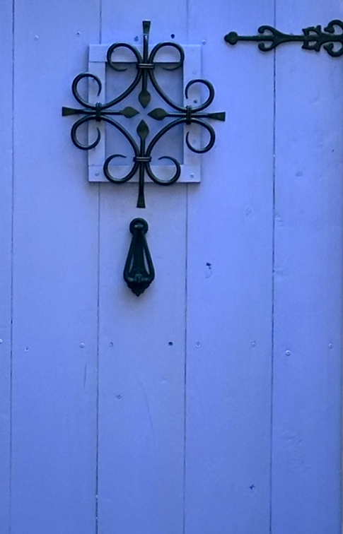 This is the speakeasy grille on Kat's secret garden door with the door knocker as examples of enchanted garden decorations.