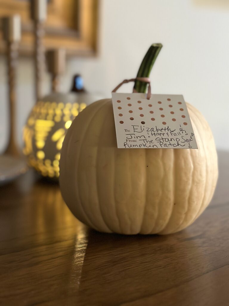 This is a photo of Kat's pumpkin on her kitchen table with an attached note to give to her friends.