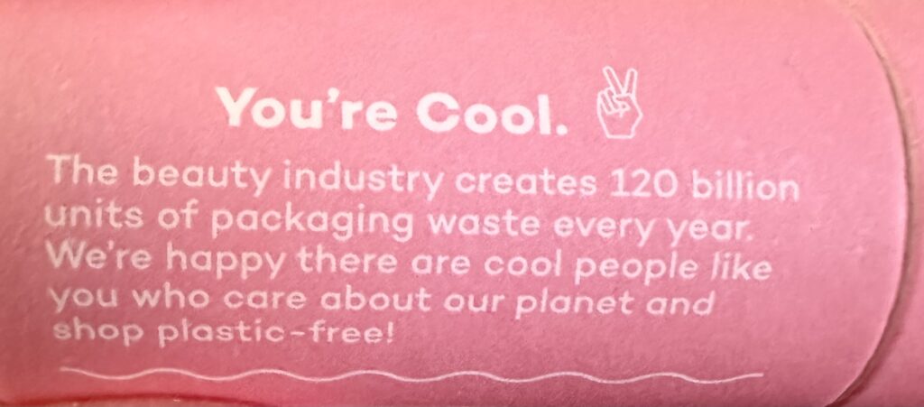 This is a photo of the axiology makeup stick label that says, "The beauty industry creates 120 billion units of packaging waste every year. We're happy there are cool people lik you who care about our planet and shop plastic-free!"