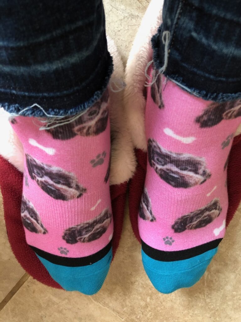 These are Kat's feet wearing socks with her dog's face on them to represent best reusable gifts.