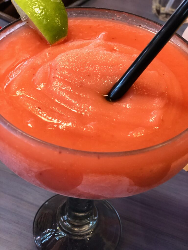 This is a huge orange, frozen margarita which is one of the best thanksgiving cocktails.