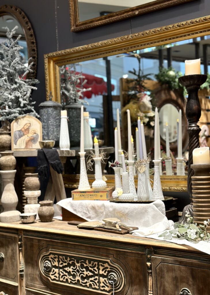 This is a beautiful antique chest with candles and mirrors and other small vintage items to suggest carbon neutral Christmas gifts.