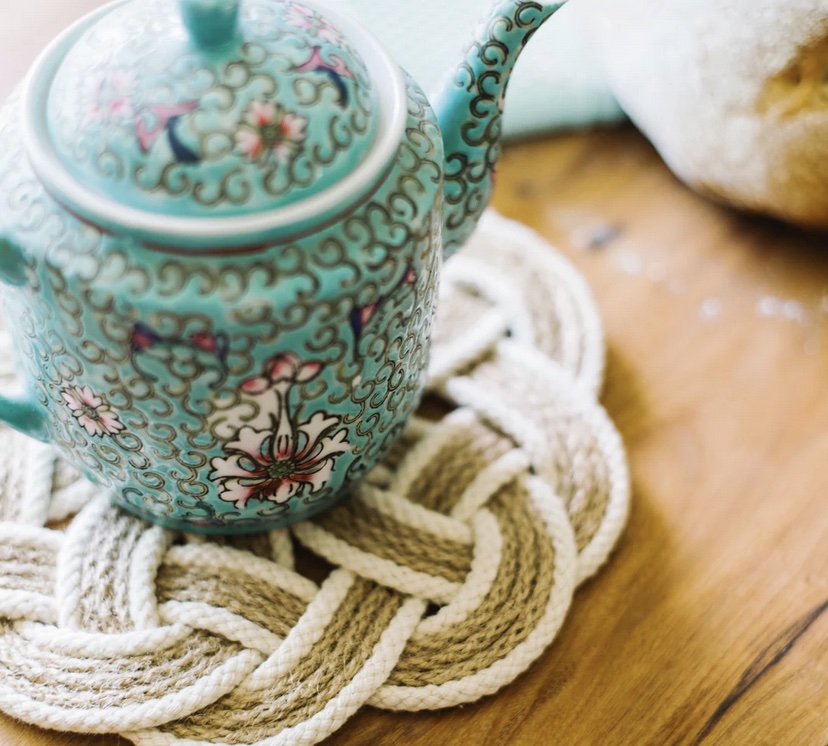 This is a beautiful teapot sitting on a  jute trivet made by Starfish Project to represent gifts for sustainability lovers.