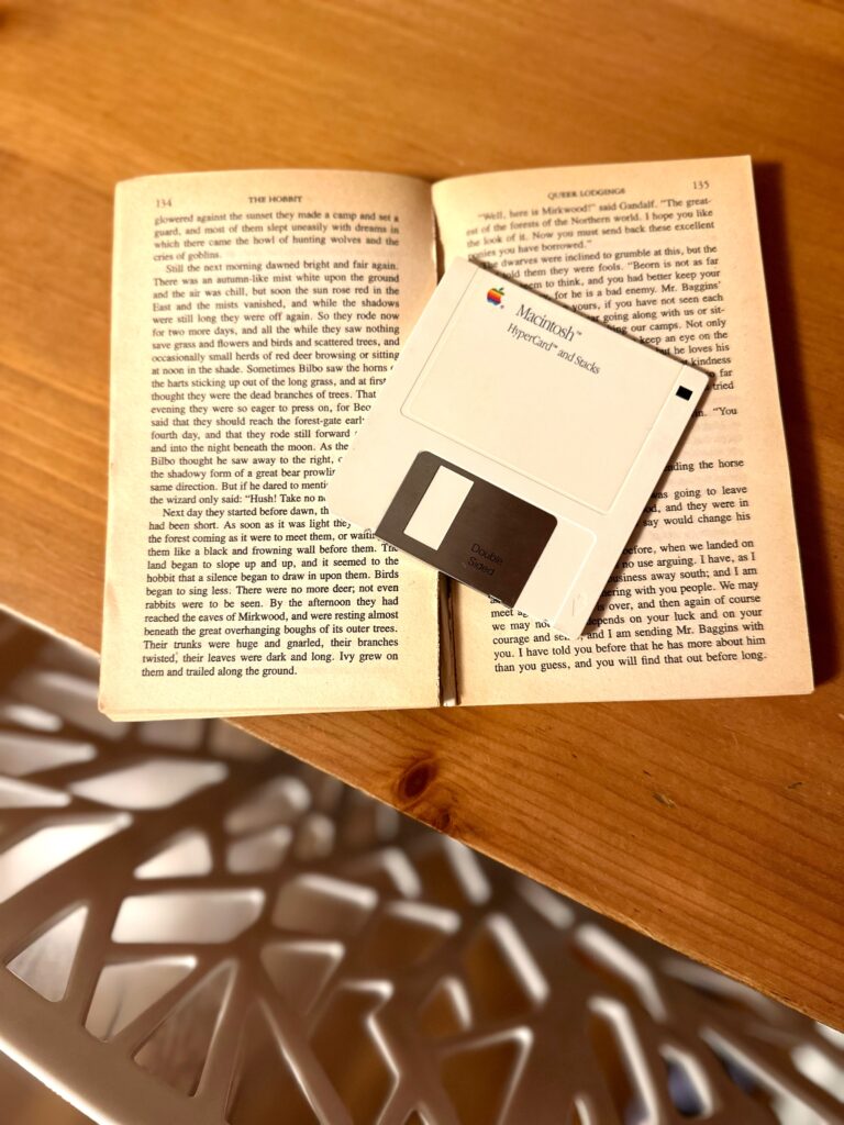 This is a photo of a book with a floppy disk as its bookmark as an example of how to go green at work