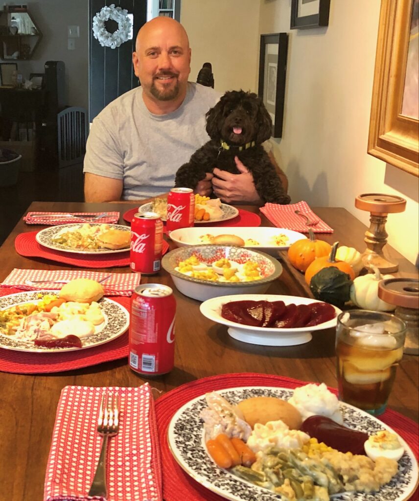 This is Kat's husband and dog at the dinner table to show how to survive thanksgiving with family.