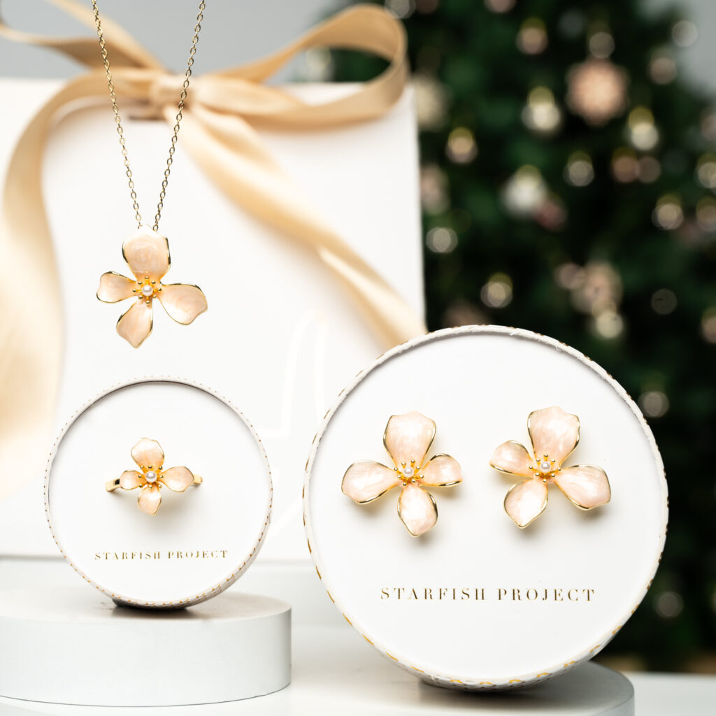 This is a Starfish Project photo of a floral necklace, ring, and earrings.