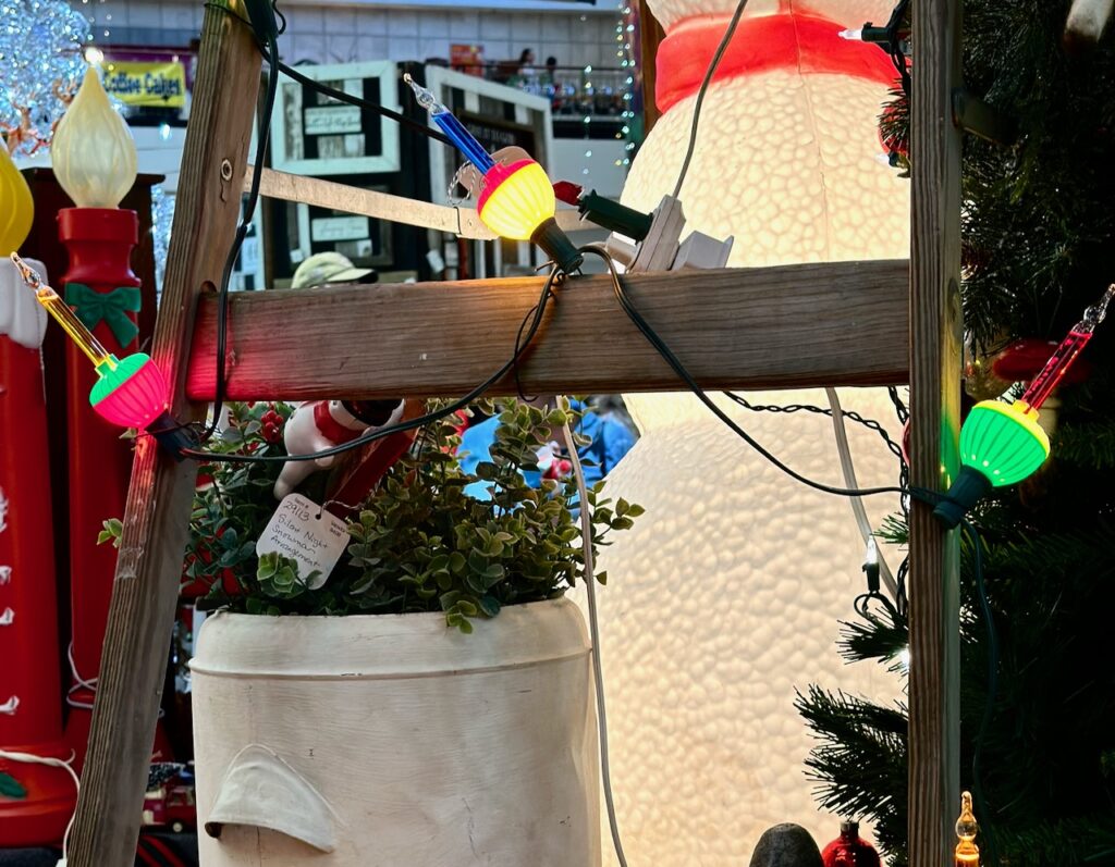 Here are some festive colorful lights wrapped around a wooden ladder to show best indoor christmas tree lights.