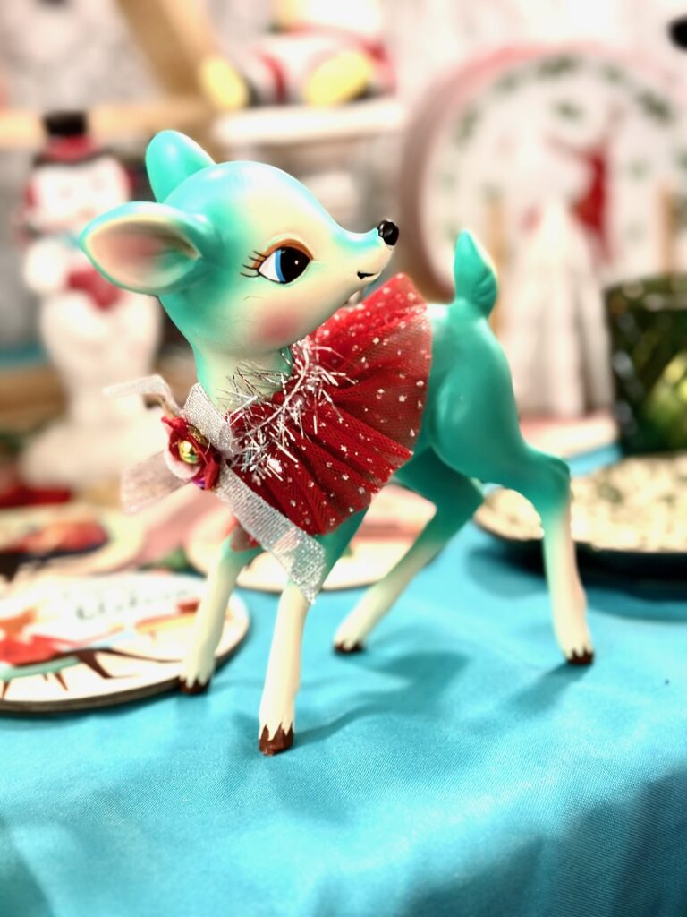 This is a retro deer figurine in an aqua color that is an example of christmas market ideas.