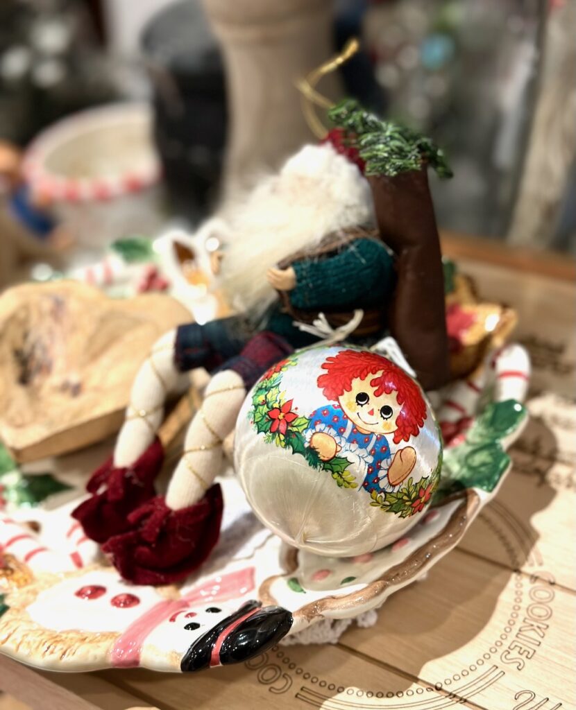 This is a felt Father Christmas and an old Raggedy Ann ornament as examples of christmas market ornaments.