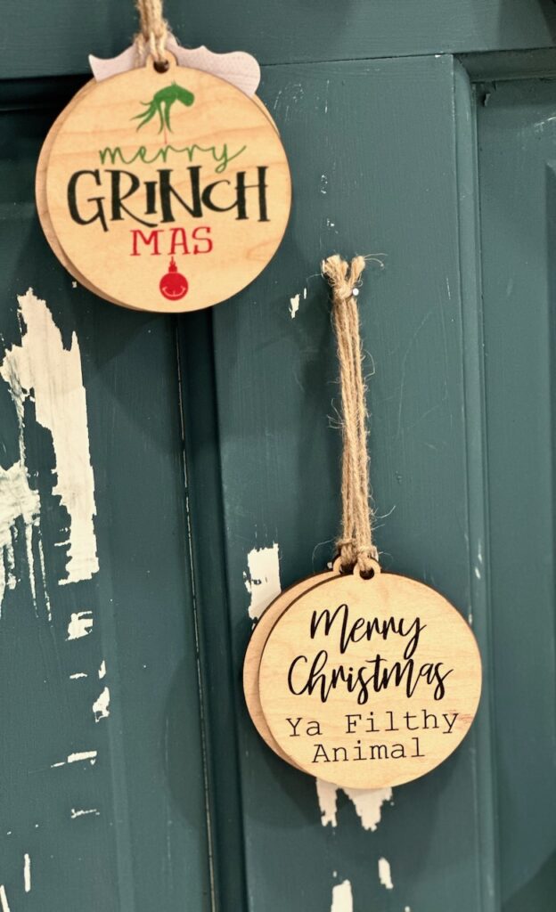 Here are some wooden ornaments with movie quotes that say, "Merry Grinchmas" and "Merry Christmas ya filthy animal" as ideas for retro christmas.