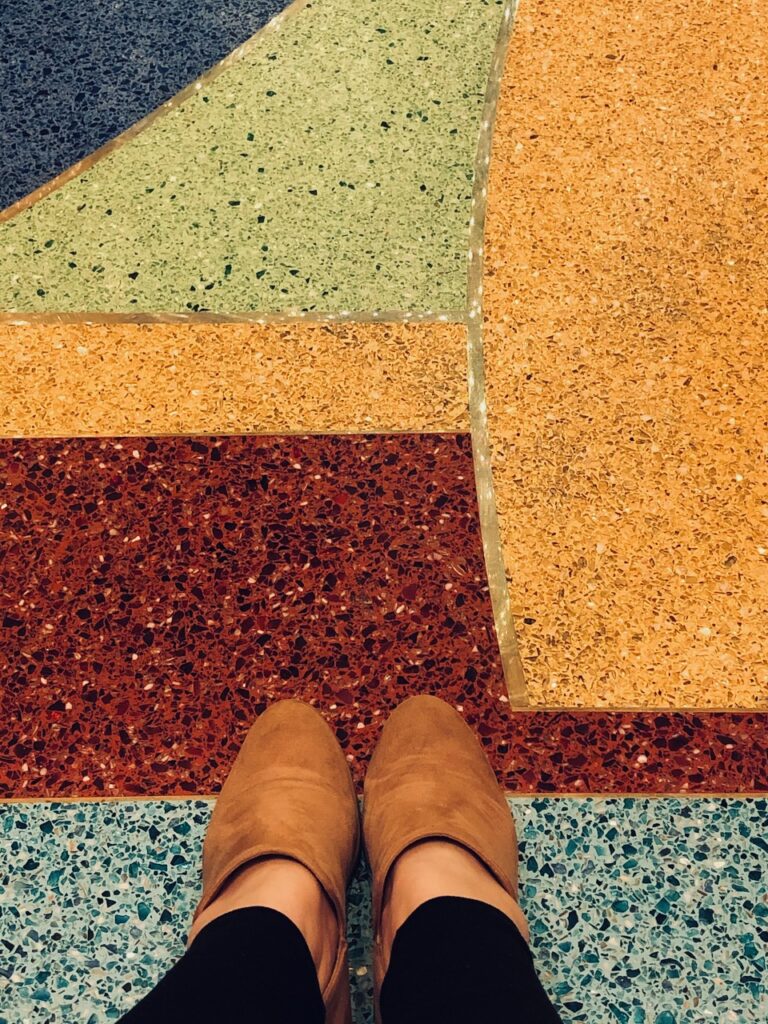 Here's a pic of a girl's feet sitting in a lobby to describe ideas on a woman with a good heart.