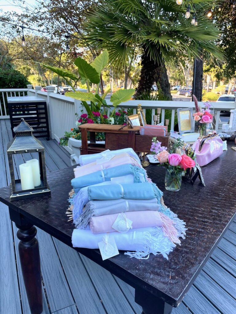 This is a photo of Kat's wedding with pashminas on the welcome table as environmentally friendly wedding favors cheap.