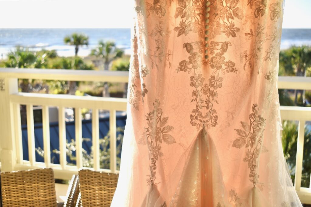 This is a photo of Kat's wedding dress by the ocean to introduce environmentally friendly wedding invitations.