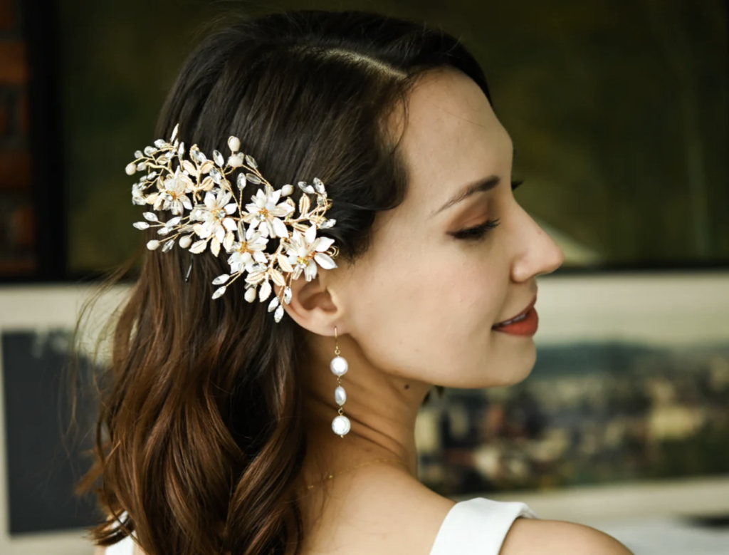 This is a bride wearing a Starfish Project hair clip as an example of forest wedding favors.