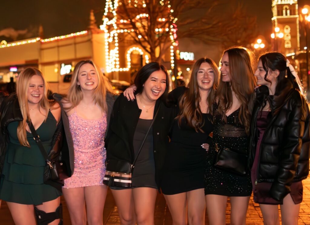 This is a photo by Kat Stano of a group of girls hanging out in the city and sticking together as an example of a good person test.