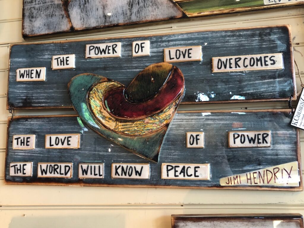 This is artwork of a quote by Jimi Hendrix that says, "When the power of love overcomes the love of power the world will know peace" as an example of a kind person definition.