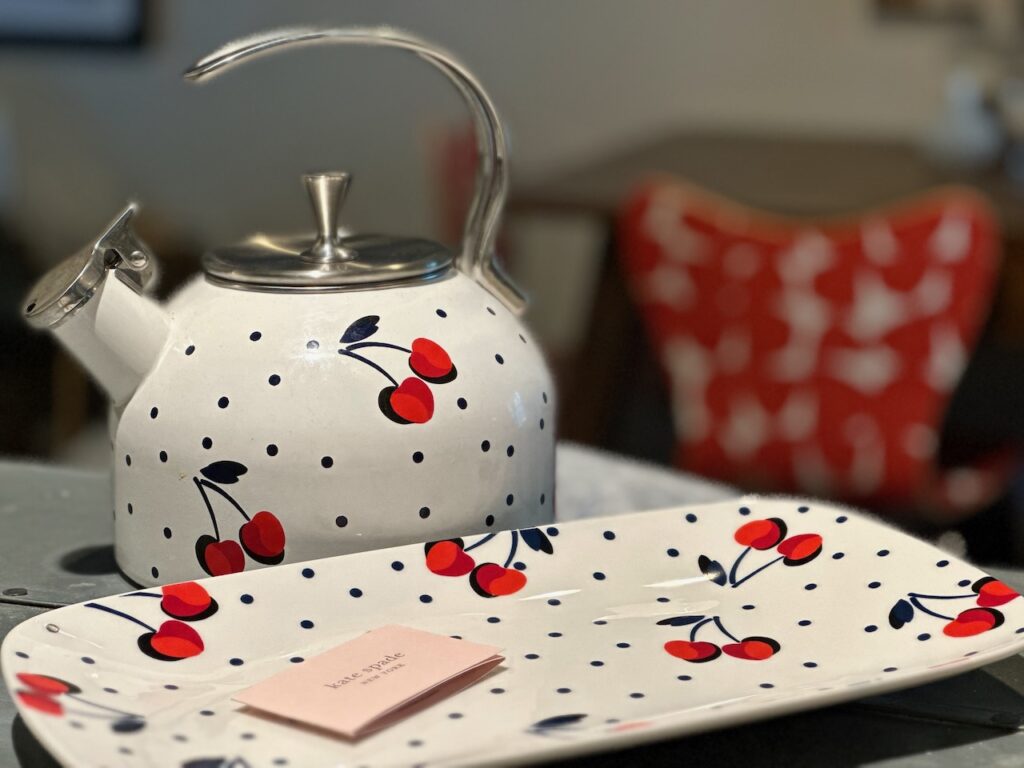 This is a tea kettle and platter with cherry designs by Kate Spade to help discuss eco friendly home ideas like The Buy Nothing Project.