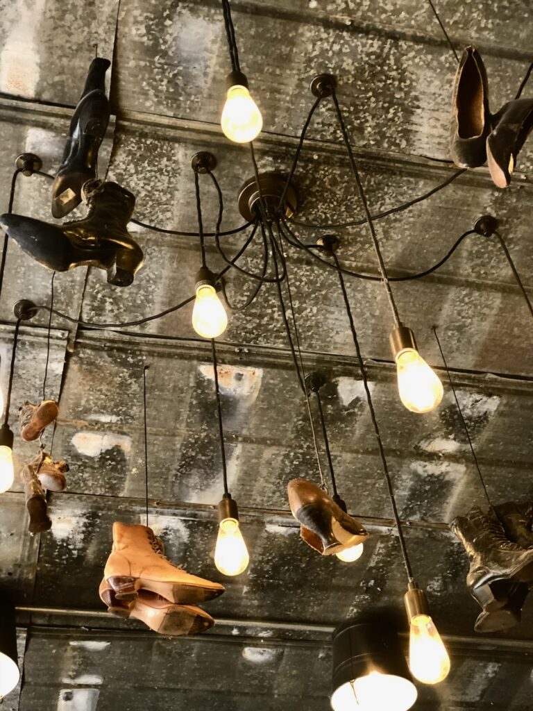 These are antique shoes hanging from the ceiling at a restaurant in Virginia to show an idea for an eco friendly house project.