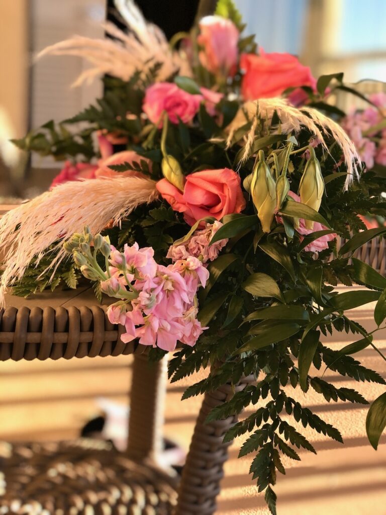 These are florals sitting on a beach balcony to show eco friendly wedding decorations.