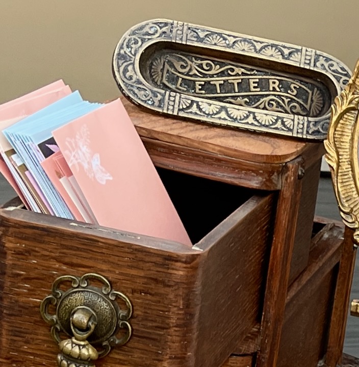 This is the Singer sewing machine drawers with cards and a "letters" antique mail slot to show eco friendly wedding planner.