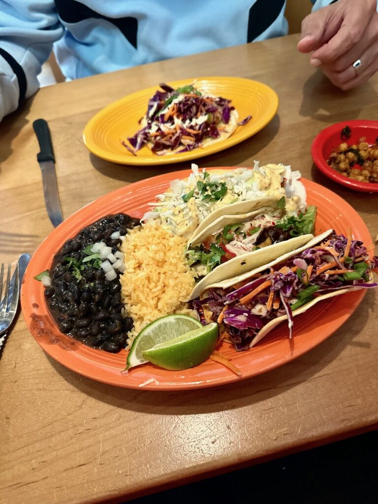 This is a spread of Mexican food siting on a table in front of a man to discuss the environmental benefits of composting.