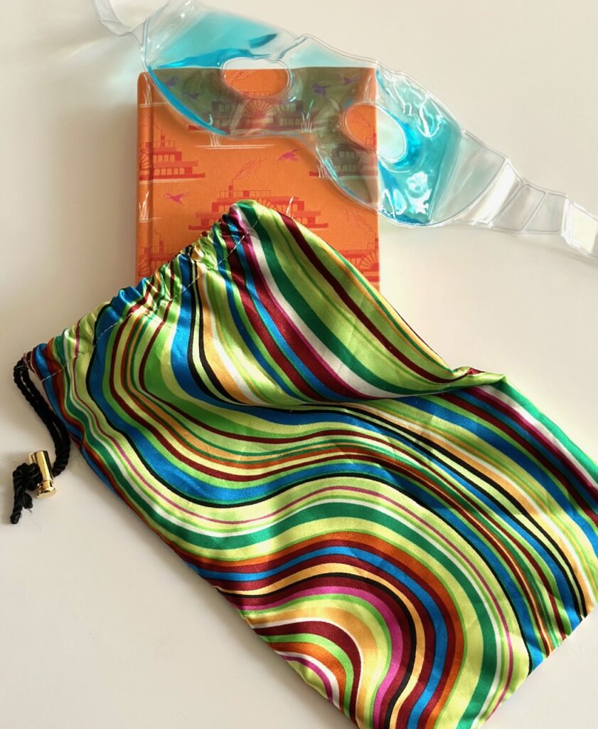 This is a gel eye mask, book, and shoe bag to illustrate home ice packs with covers.