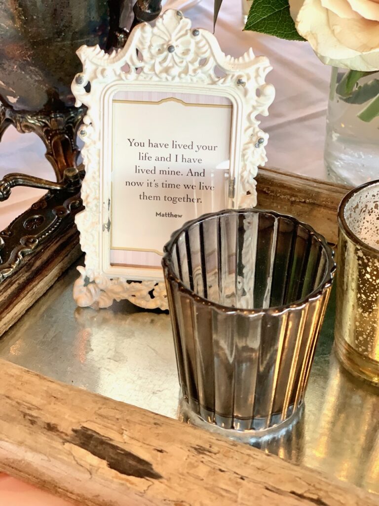 This is a framed quote from Kat's wedding that says, "You have lived your life and I have lived mine and now it's time we live them together." from Downton Abbey to show sustainable wedding ideas.