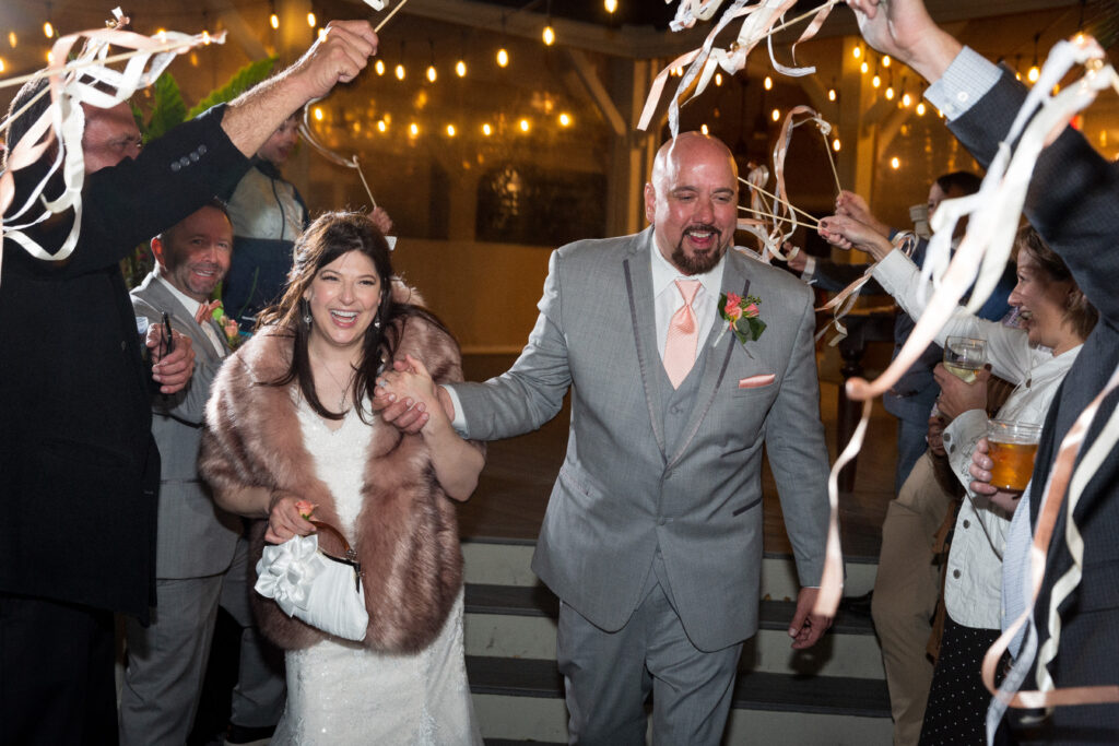 This is Kat and Jon leaving their wedding reception with streamers to show winter wedding send off ideas.