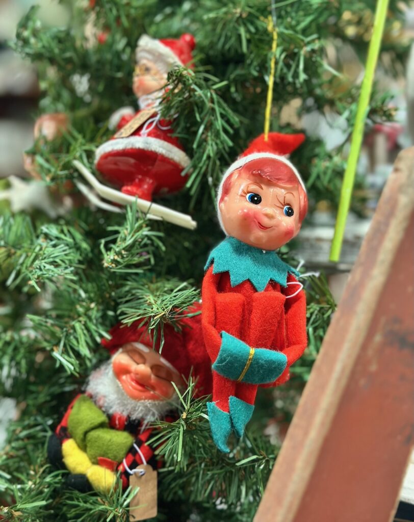 This is a vintage elf ornament, alongside another elf and Mrs. Claus on a Christmas tree to show eco friendly christmas ornaments.