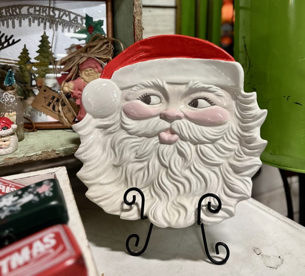 This is a Santa ceramic plate on a plate stand to show homemade sustainable christmas decorations.