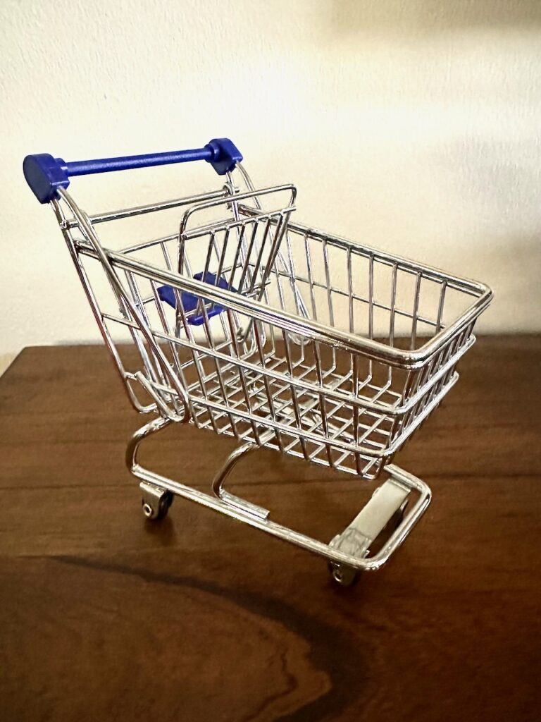 This is a desk-size metal grocery cart to share what to donate to food banks.