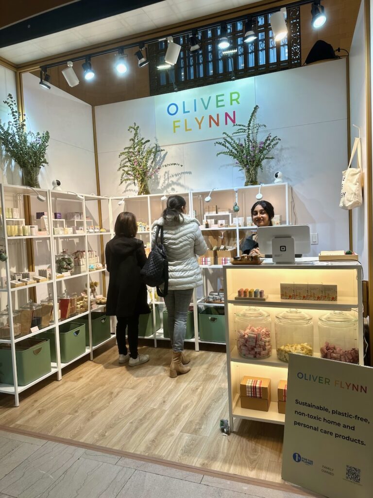 This is a nice Oliver Flynn employee at a Christmas market in New York to show Oliver Flynn compostable makeup.