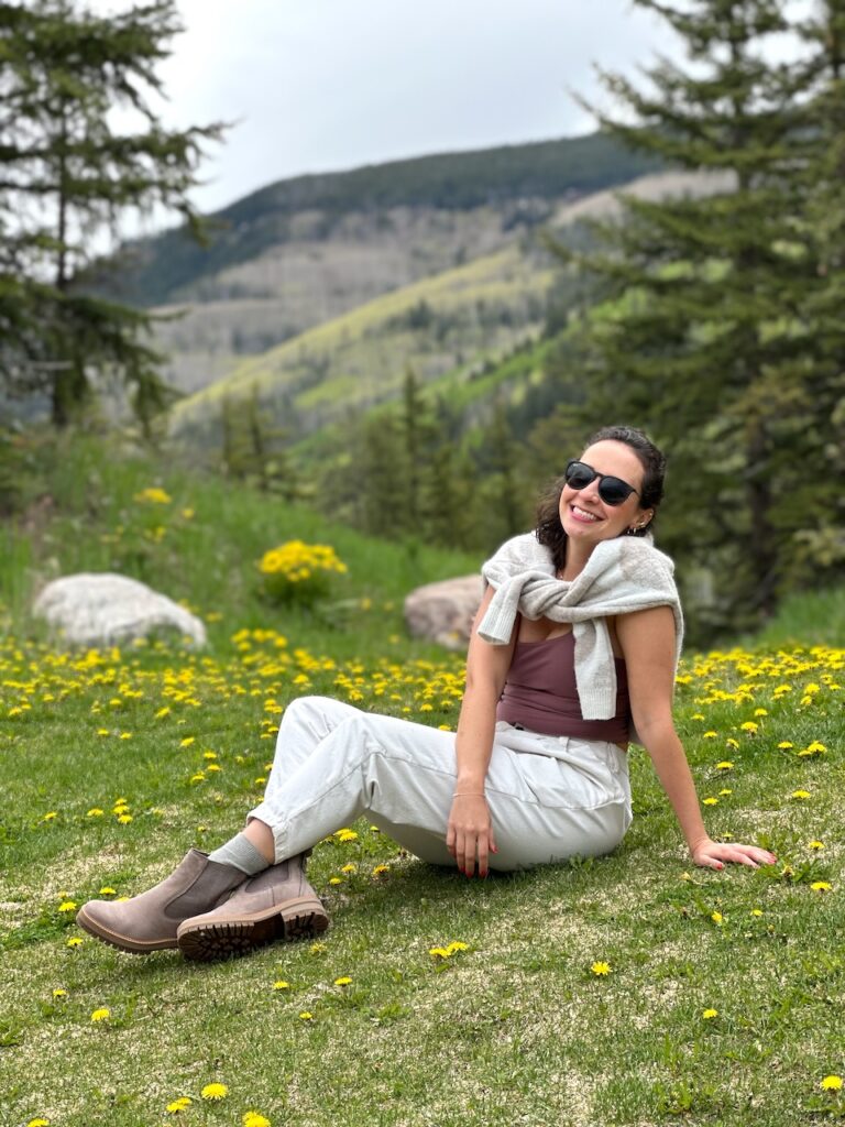 This is a cute girl sitting in a dandelion field in Colorado.